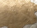 The flower at the center of this blanket is beautiful yet simple to knit.