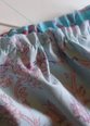 Pull thread tails to gather each side of the skirt.  Keep gathers consistent.